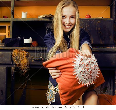 Young Pretty Teenage Girl In Halloween Holiday Decorated Interio