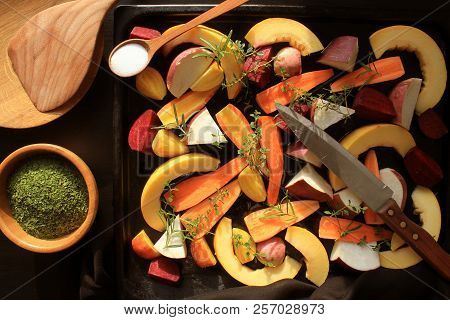 Top View Of Pan Full Of Fall Seasonal Vegetables Ready To Be Grilled Over A Dark Background
