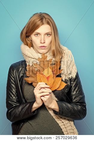 Fashion Model With Stylish Hair In Scarf. Woman With Autumn Leaves In Leather Jacket. Season And Aut