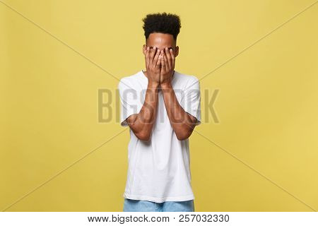 Closeup Portrait Man With Sad Expression, Isolated On Yellow Wall Background. Human Emotions, Body L