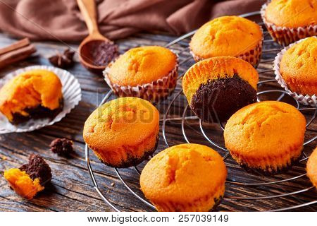 Close-up Of Pumpkin Muffins For Potluck Or Halloween Party. Ingredients On A Wooden Table, View From