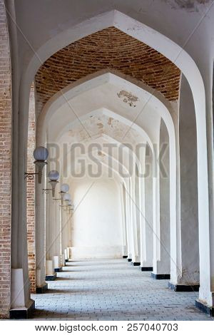 White Arabian arches in Kolon mosque. Bukhara. Uzbekistan. Central Asia.