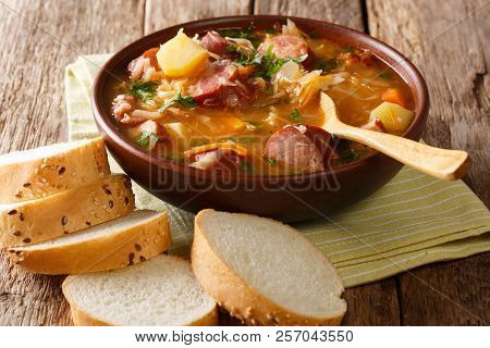 Authentic Czech Cabbage Soup With Sausages And Vegetables Close-up In A Bowl. Horizontal