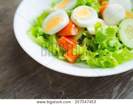 Close Up Healthy Bowl Of Homemade Salad With Fresh Vegetables, Crab Stick, Eggs