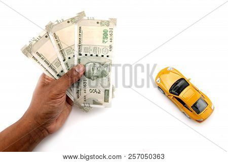 Indian Currency Notes And Toy Car In The Hands Bank Loan Concept