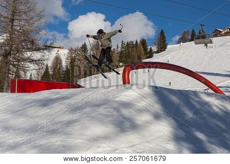 Skier In Action: Ski Jumping In The Mountain Snowpark.