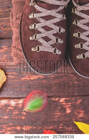 Brown Man Suede Boots With Sweater On Wooden Background