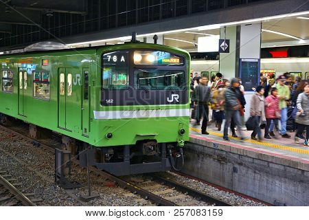 Osaka, Japan - November 23, 2016: Passengers Board Jr Train At Tennoji Station In Osaka, Japan. Jr W