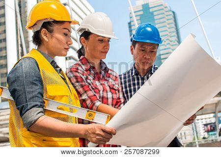Three Industrial Engineer Wear Safety Helmet Engineering Working And Talking With Drawings Inspectio