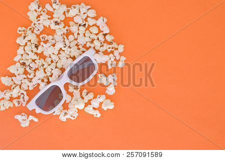 3d Glasses And Popcorn Are Isolated On A Orange Background. Flat Lay. Copyspace. Cinema Concept.