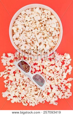 Cup With Popcorn And 3d Glasses On A Red Background, Top View. Cinema Concept. Flat Lay. Copyspace.