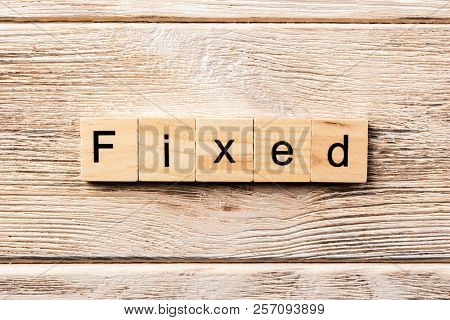 Fixed Word Written On Wood Block. Fixed Text On Table, Concept.