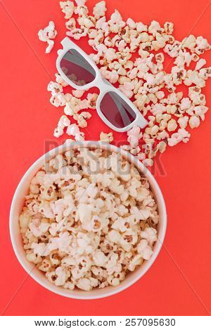 Background. Popcorn, Cup And 3d Glasses On A Colored Red Background. Flat Lay. Copyspace. Cinema Con