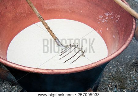 Big Pot Where A Cheesemaker Are Making Cheese From The Milk