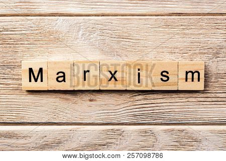 Marxism Word Written On Wood Block. Marxism Text On Table, Concept.