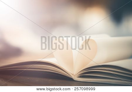 Concept Of Love In Valentine Day. Cinematic Tone Book Page Decorate To Heart Shape On Wooden Table W