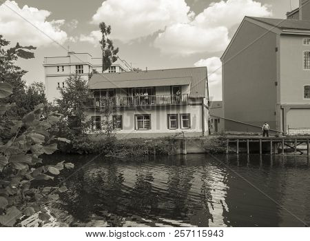 Czech Republic, Jizera, July 28, 2018: Old Houses On Jizera River Bank, Gypsy People Looking From Ba