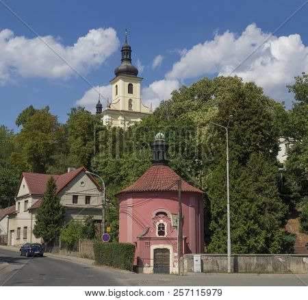 Czech Republic, Horky Nad Jizerou, July 28, 2018: Street With Pink Rococo Chapel And Baroque Church,