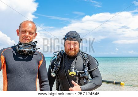 Scuba Divers In A Suit For Diving Having Fun
