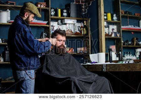 Hipster Client Getting Haircut. Barber With Hair Clipper Work On Hairstyle For Hipster, Barbershop B