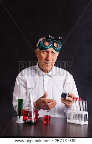 An Old Chemist Provides Experiments. Girl Doing A Chemical Experiment