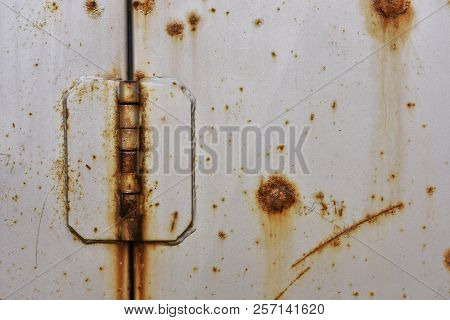 A Close Up Image Of An Old Rusted Metal Door Hinge.