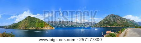A Panorama Of The Black Mountains Surrounding The Bright Blue Gulf Of The Bay, Cutting White Yachts.