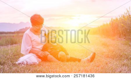 Grandmother, Daughter And A Dog With Happy Family Enjoying Life Together At Meadow; Light And Lens F