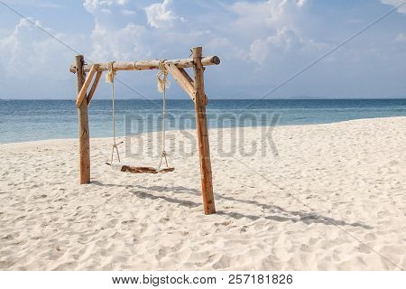 Wooden Swing On The Sand Beach For Summer Holiday Concept.