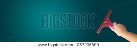A Hand Washes A Window. On Green Background