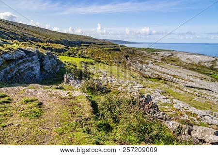 Fanore Beach In Burren Mountain With Farm And Rocks