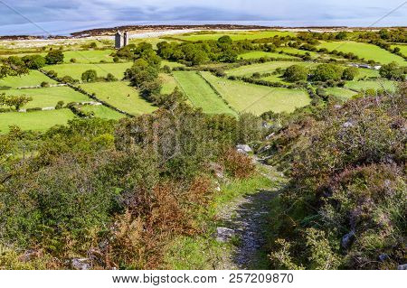 Burren Way Trail With Old Rock Tower, Farm And Beach In Background
