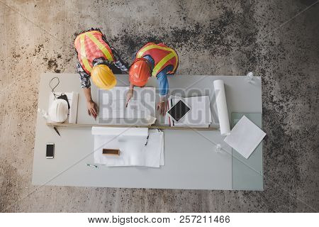 Top View Of Architects And Engineers To Help Create A Blueprint To Build A Modern Building Equipped