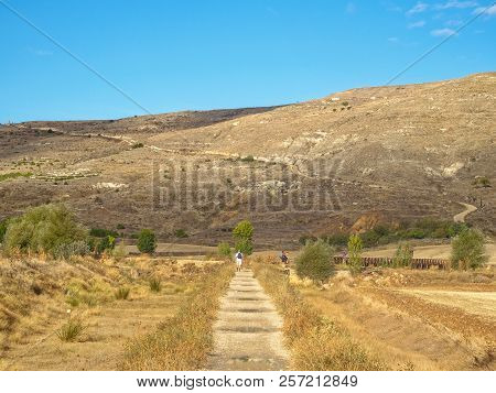 Pilgrims Approach The Strenuous Climb Up To Alto De Mostelares - Castrojeriz, Castile And Leon, Spai