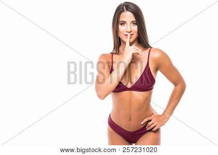 Woman Requires Silence. Young Beautiful Woman In Bikini Put Forefinger To Lips As Sign Of Silence