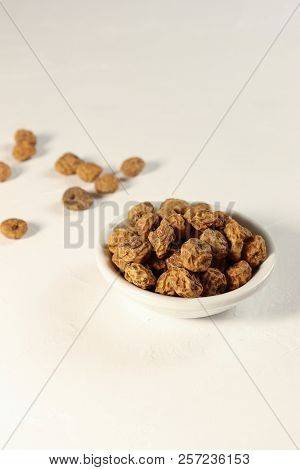 Tigernuts / Earth Almonds / Nutsedges In A Small Bowl, On White Surface, Copy Space