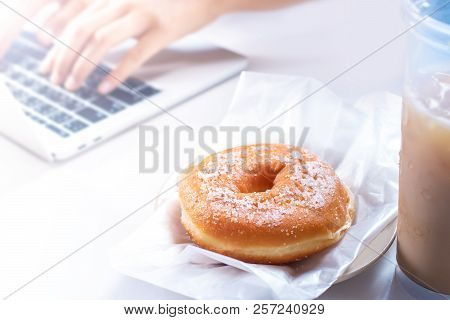 Eating Junk Food And Sweet Bread On The Computer Desk.