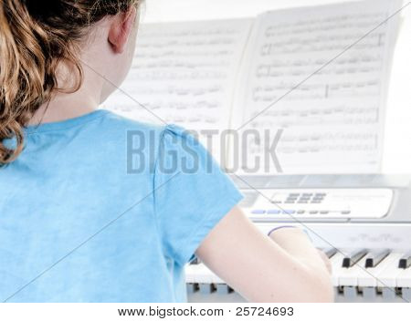 Young girl playing electric piano