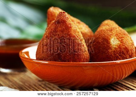 Coxinha Street Food. Brazilian Chicken Coxinha Over Rustic Background.