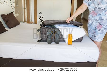 Coming To Hotel Room And Unpacking. Summer Vacation Concept