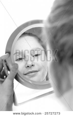 girl looking at reflection in mirror