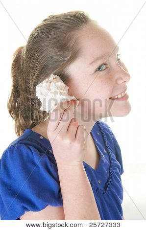 girl listening to seashell sounds