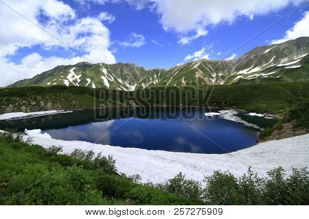 Mikurigaike Pond And Tateyama Mountain Range With Snow In Summer In Toyama, Japan
