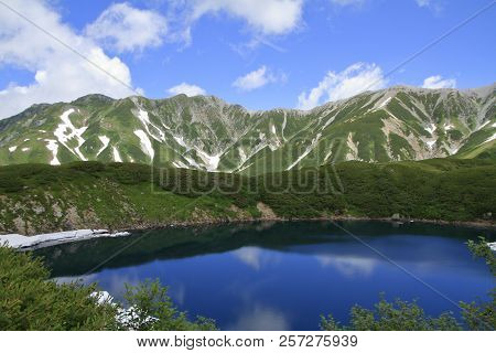 Mikurigaike Pond And Tateyama Mountain Range With Snow In Summer In Toyama, Japan