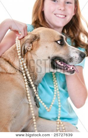 girl putting jewelry on dog