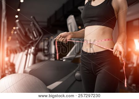 Sporty Woman Using Waist Tape Line In Fitness Gym Sport Club Training Center Near Window With Condom