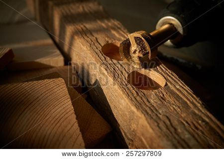 Close Up Forstner Bit For Drilling Circular Holes With A Portable Drill Sitting On Top Of Wooden Blo