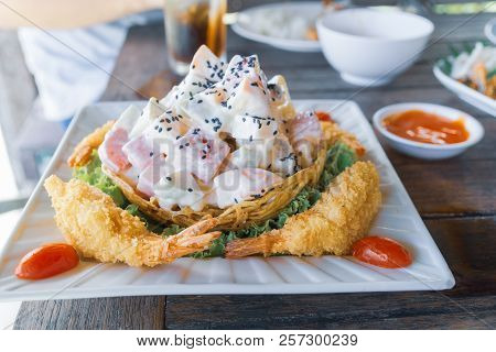 Shrimp Fried Salad With Cream On Square Plate