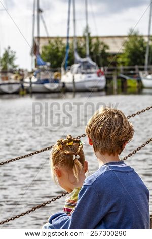 Brother And Sister Enjoying Their Vacation In The Harbour