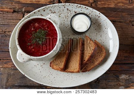 Traditional Ukrainian Russian Borscht With White Beans On The Bowl. Plate Of Red Beet Root Soup Bors